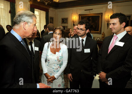 The Prince of Wales (left) talks to community volunteer workers from Scotland, during a reception for the Hope 08 initiative at Clarence House in central London. Stock Photo