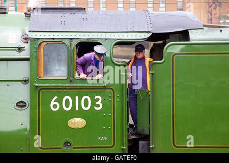 Engine driver & fireman in the cab of steam train LNER A3 Class 4-6-2 no 60103 Flying Scotsman. Carlisle Railway Station, UK. Stock Photo