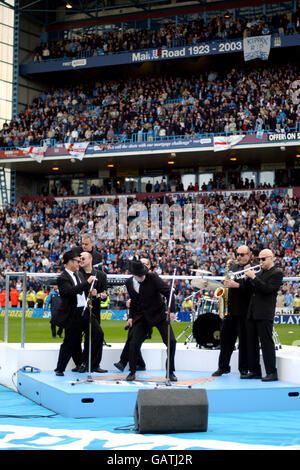 A Blues Brothers tribute band entertain the crowd at Maine Road Stock Photo