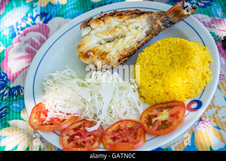 Grilled lobster with rice and salad on a beach restaurant in Cuba Stock Photo