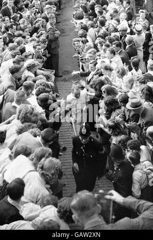 Australia's Don Bradman makes his way back to the pavilion through crowds of well-wishers after helping his team to victory with an unbeaten 173 on the final day. Australia set a new test record (which stood until 1975) by scoring 404 in their second innings to win the game Stock Photo