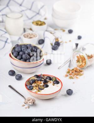 Natural Greek yogurt served with assorted toppings Stock Photo