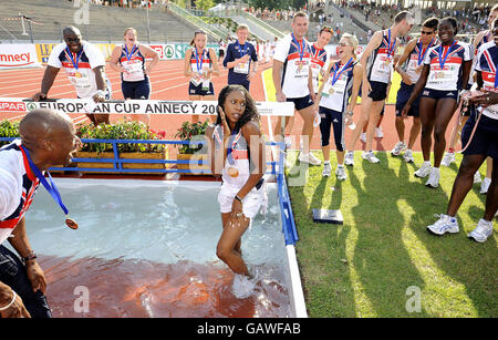 The GB Mens Athletics team celebrate their victory in the Event at the Spar European Cup as they throw their captain Marlon Devonish into the Water Jump where he is joined by Natasha Danvers the Womens Team Captain at Annecy, France. Stock Photo