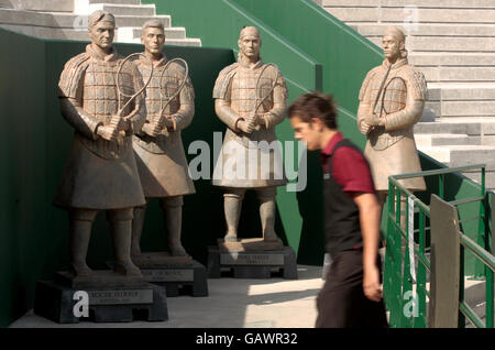 A man walks past statues of Roger Federer, Novak Djokovic, David Ferrer and Fernando Gonzalez on the new court 2, which will open next year, during the Wimbledon Championships 2008 at the All England Tennis Club in Wimbledon. Stock Photo