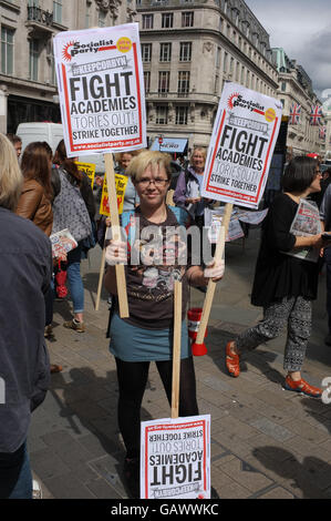 London, UK. 05th July, 2016. A woman holds up placards saying 'Keep Corbyn' and 'Fight Academies' at a demonstration in support of striking teachers at Oxford Circus in July 2016 Credit:  Jonathan Katzenellenbogen/Alamy Live News, Stock Photo