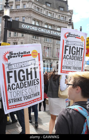 London, UK. 05th July, 2016. A woman holds up placards saying 'Keep Corbyn' and 'Fight Academies' at a demonstration in support of striking teachers at Oxford Circus in July 2016 Credit:  Jonathan Katzenellenbogen/Alamy Live News Stock Photo