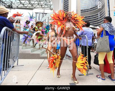 Toronto, Canada. 5th July, 2016. Dressed up revellers perform during the official launch ceremony of the 2016 Toronto Caribbean Carnival at Nathan Philips Square in Toronto, Canada, July 5, 2016. As the largest cultural festival of its kind in North America, the annual exciting three-week cultural explosion of Caribbean music, cuisine and revelry as well as visual and performing arts kicked off on Tuesday. Credit:  Zou Zheng/Xinhua/Alamy Live News Stock Photo