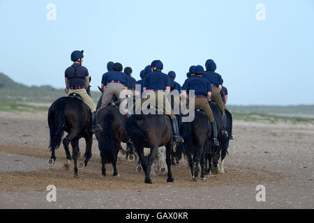 Holkham beach, Norfolk, UK. 6th July, 2016. The Household Cavalry exercise and train on Holkham beach Norfolk as part of their summer break. The horses and riders spend around three weeks summer training at Bodney camp in the heart of the Norfolk countryside close to Thetford, with the main aim for the men to undergo vital training as a regiment without the distraction of public duties. Only a minimum staff remains at the Hyde park barracks during this period to allow as many as possible to attend the training. Credit:  MARTIN DALTON/Alamy Live News Stock Photo