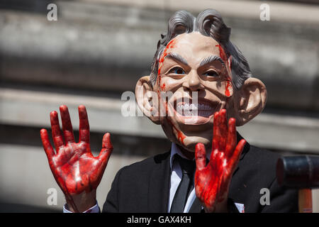 London, UK. 6th July, 2016. A protester wearing a Tony Blair mask and with bloodied hands addresses protesters waiting for the publication of the Chilcot Report outside the Queen Elizabeth II Centre. The protest was organised by Stop The War Coalition. Credit:  Mark Kerrison/Alamy Live News Stock Photo