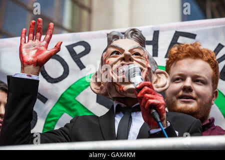 London, UK. 6th July, 2016. A protester wearing a Tony Blair mask and with bloodied hands addresses protesters waiting for the publication of the Chilcot Report outside the Queen Elizabeth II Centre. The protest was organised by Stop The War Coalition. Credit:  Mark Kerrison/Alamy Live News Stock Photo