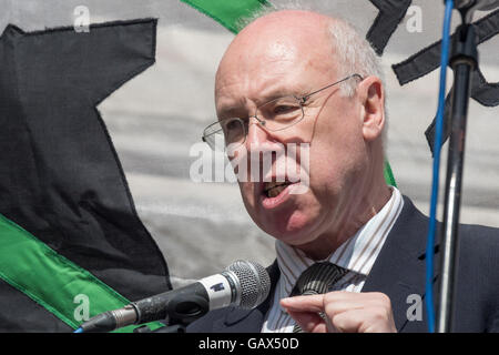 London, UK. 6th July 2016. SNP MP George Kerevan takes part in a 'Naming of the Dead', speaking about the Iraq War and Chilcot. He called for a silence for the victims of the Baghdad bombing and an end to UK military involvement in Middle East wars and promised that MPs will work to see justice delivered before reading the names and brief details of some of the Iraqi and British vicitms of the Iraq war at a protest at the QEII Centre on the morning the Chilcot report was being published demanding that Tony Blair, who lied and deceived MPs and the British people to wage an illegal war on Iraq,  Stock Photo