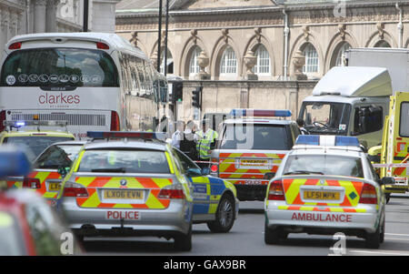 Emergency Services attend the scene of an accident involving a Police motorcycle and a lorry on Buckingham Gate, central London.
