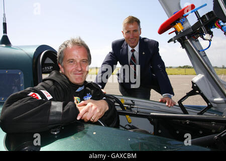 Test driver Don Wales, grandson of Sir Malcolm Campbell, sits in the British-built steam car, pictured with Wing Cdr Andy Green, as the steam car is unveiled to the public for the first time at Thorney Island, near Portsmouth. Stock Photo
