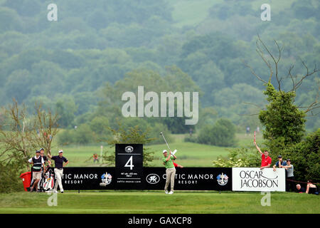 Ross Fisher tees off on the fourth hole during round three at The Celtic Manor Resort Stock Photo