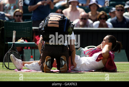 Serbia's Jelena Jankovic receives treatment for a injury on court during the Wimbledon Championships 2008 at the All England Tennis Club in Wimbledon. Stock Photo