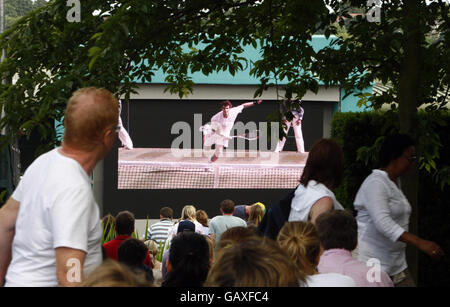 Fans watch Andy Murray in action on the big screen on Murray Mount during the Wimbledon Championships 2008 at the All England Tennis Club in Wimbledon. Stock Photo