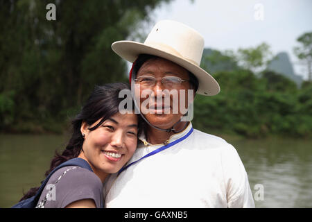 A candid portrait of a Tibetan man and a younger woman who is half Tibetan and half Muslim Hui. Li River near Yangshuo, China Stock Photo