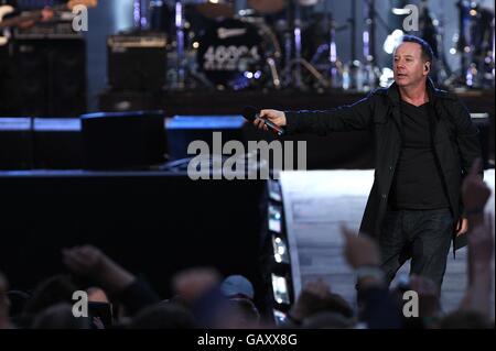 Jim Kerr, lead singer of the British pop band Simple Minds, performs during the 46664 concert honouring Nelson Mandela's ninetieth birthday in Hyde Park, London. Stock Photo