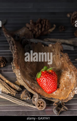 Strawberry with rustic decor in a wooden table. Vertical image. Stock Photo
