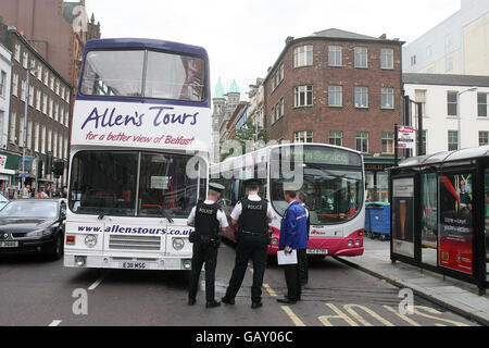 A Translink Metro bus (left) that was damaged when Allen's Tours bus crashed into the back of it on Chichester Street in Belfast, Northern Ireland. Stock Photo