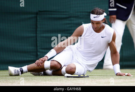 Spain's Rafael Nadal reacts after falling in his Mens Final against Switzerland's Roger Federer during the Wimbledon Championships 2008 at the All England Tennis Club in Wimbledon. Stock Photo