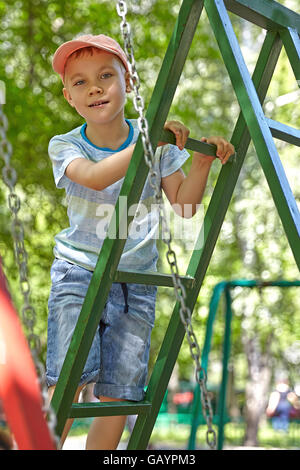 Cute boy playing in tunnel on playground Stock Photo