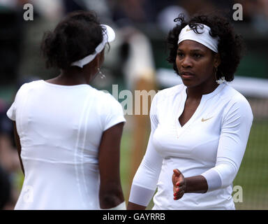 USA's Serena (right) and Venus Williams in action against USA's Lisa Raymond and Australia's Samantha Stosur in the women's doubles final during the Wimbledon Championships 2008 at the All England Tennis Club in Wimbledon. Stock Photo