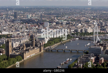 Aerial photo of the Houses of Parliament and Big Ben (left), Westminster Bridge (bottom), Hungerford Bridge (top) and the London Eye (right) alongside the River Thames, London.
