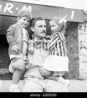 Current world champion Graham Hill photographed in the pits with son Damon and daughter Brigitte during practice for tomorrow's British Grand Prix at Silverstone Stock Photo