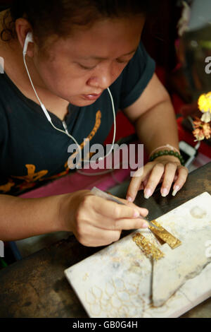 Traditional Thai jewelry being made in the Somsak gold factory near Sukhothai Stock Photo