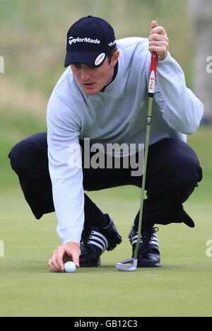 Justin Rose, of England, lines up his putt on the 14th green during the ...