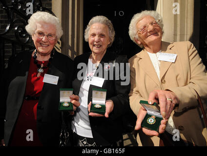 Former Land Girls from left to right, Lily Copping, from Bradford, West Yorkshire, Mary Highly from Illingworth, Halifax and Dorothy Giles from Bridport, Dorset after a ceremony at 10 Downing Street in London, for around fifty surviving members of the Women's Land Army (WLA) and the Women's Timber Corps (WTC) who received commemorative badges from Environment Secretary Hilary Benn. Stock Photo