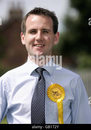 Glasgow East by-election candidate for the Liberal Democrats Ian Robertson stands with supporters at Carmyle Commnunity centre, Glasgow, as voters go to the polls in the by-election. Stock Photo