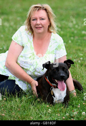 EMARGOED TO 0001 WEDNESDAY JULY 30 Denise Winters with Staffordshire Terrior, Dennis, at the RSPCA Southridge Animal Centre, Potters Bar. Dennis has been abused in the past and has since been rehabilitated at the Southridge Animal Centre. Stock Photo