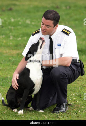 EMARGOED TO 0001 WEDNESDAY JULY 30 RSPCA Inspector Simon Osbourne with dog Warrier, at the RSPCA Southridge Animal Centre, Potters Bar. Abused by his previous owners, Warrier recovered from his injuries at the Southridge Animal Centre. Stock Photo