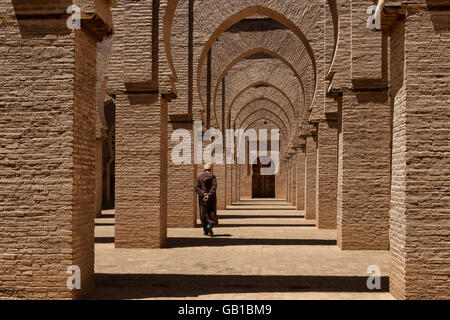 Traditional dressed man walks inside the Tinmal mosque, Morocco. Stock Photo