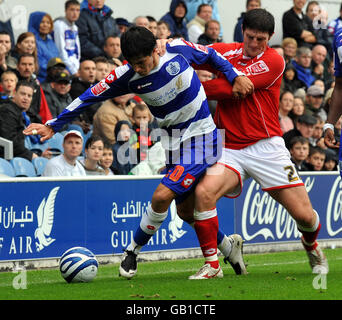 Emmanuel Ledesma (left) of Queen's Park Rangers, in action against John Macken of Barnsley during the Coca-Cola Football Championship match at Loftus Road, London. Stock Photo