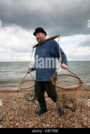 Neill Austin, dressed as a traditional oyster fisherman, brings the first catch of the season to shore at the start of the Oyster Festival in Whitstable, Kent. Stock Photo