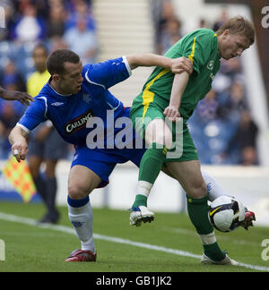 Rangers' Charlie Adam battles with FBK Kaunas Linas Pilibaitis during the UEFA Champions League Qualifying Second Round First Leg match at Ibrox, Glasgow. Stock Photo