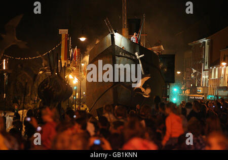 The grand finale of the Spraoi Festival, as a giant replica steam ship 'the Iron Tide' sails up the quays of Waterford City, Ireland, which use to be home to some of the biggest steam ships in the world. Stock Photo