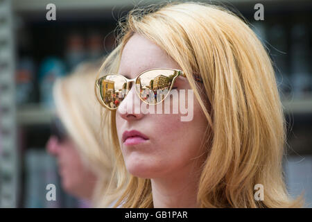 Reflections of Columbia Road Flower Market in young woman's sunglasses, London UK in July Stock Photo