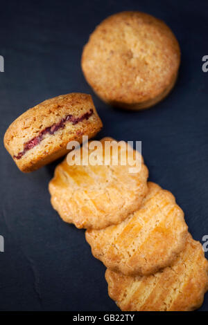 Crispy shortbread cookies filled with raspberry cream Stock Photo