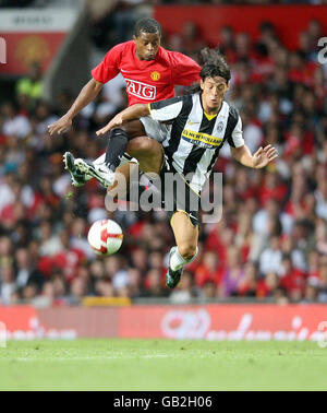 Manchester United?s Patrice Evra (R) challenges Bayern Munich?s ...