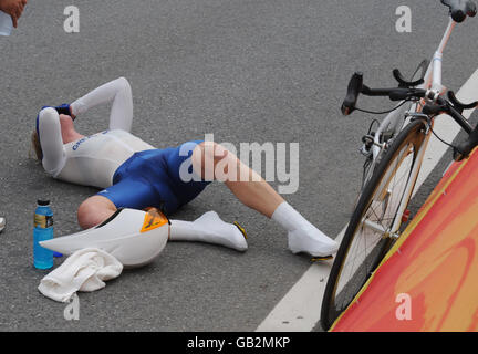 Great Britain's Nicole Cooke collapses exhausted following the Women's Individual Time Trial at the Road Cycling Course at the 2008 Beijing Olympic Games in Beijing, China. Stock Photo