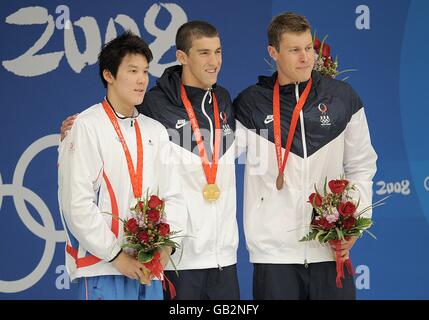 l-r Silver Medalist Taehwan Park of Korea, Gold Medalist Michael Phelps of the USA and Bronze Medalist Peter Vanderkaay after competing in the Men's 200m Freestyle Final during the 2008 Olympic Games in Beijing. Stock Photo