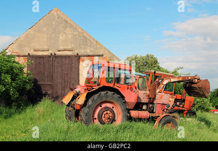 view on old tractors in a rural scene by daylight and blue sky Stock Photo