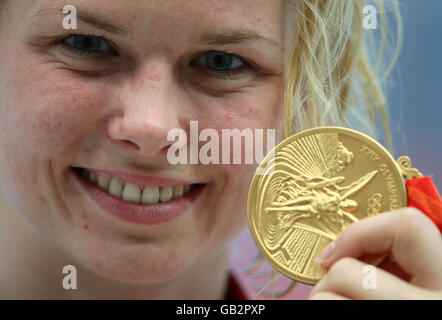 Germany's Britta Steffen celebrates with her gold medal after winning the women's 100m freestyle final. Stock Photo