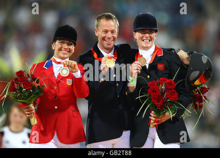 Great Britain's Tina Cook (right) with the bronze medal that she won riding Miners Frolic in the individual eventing class at the Olympic Equestrian Centre at Shatin in Hong Kong, China, is joined on the winners' podium by Germany's Hinrich Romeike (Gold, centre) and Gina Miles of the United States (Silver, left) . Stock Photo