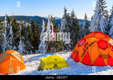 GORCE MOUNTAINS, POLAND - FEB 14, 2015: colorful tents of winter camp located near Turbacz shelter. Every February tourists lear Stock Photo