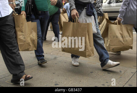 Shoppers carry brown paper Primark shopping bags on Oxford Street in London. Stock Photo
